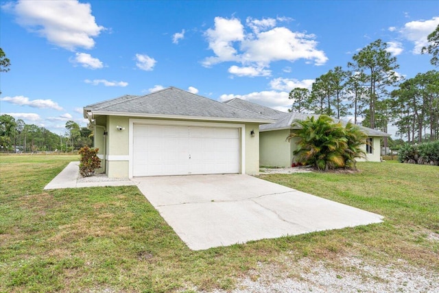 view of front of home with a front yard and a garage