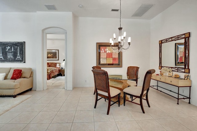 dining space with a notable chandelier and light tile patterned floors