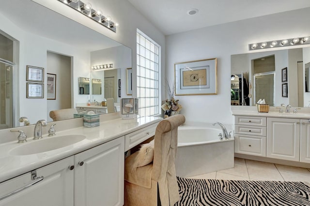 bathroom featuring tile patterned floors, vanity, and shower with separate bathtub