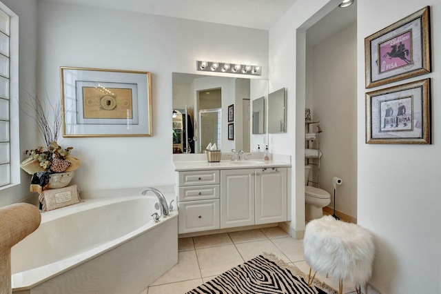 full bathroom featuring toilet, vanity, tile patterned floors, and separate shower and tub