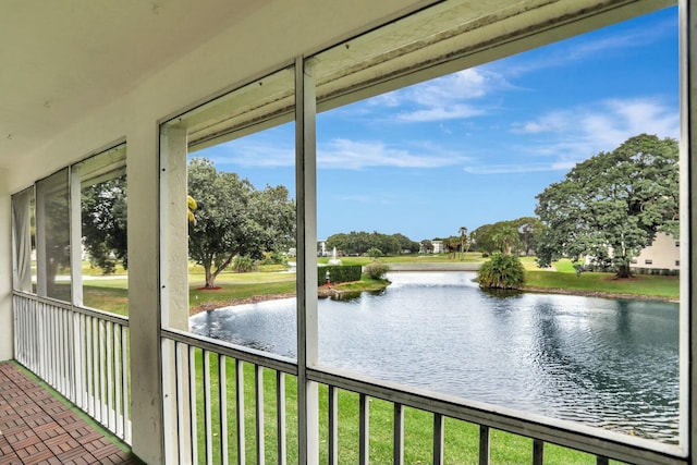 unfurnished sunroom featuring a water view