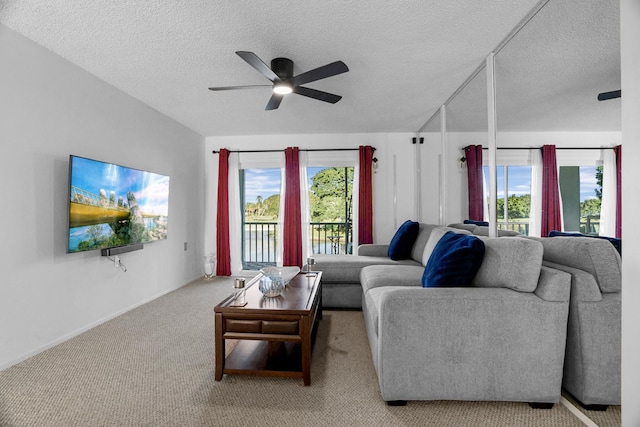 carpeted living room featuring a textured ceiling and ceiling fan