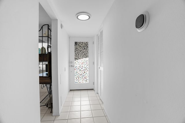 corridor featuring light tile patterned floors