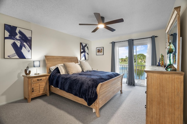 bedroom featuring a textured ceiling, ceiling fan, access to outside, and light colored carpet