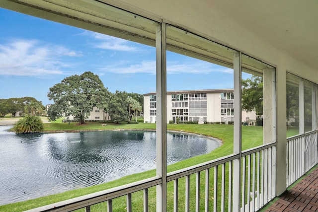 unfurnished sunroom with a water view