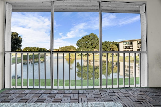 unfurnished sunroom with a healthy amount of sunlight and a water view