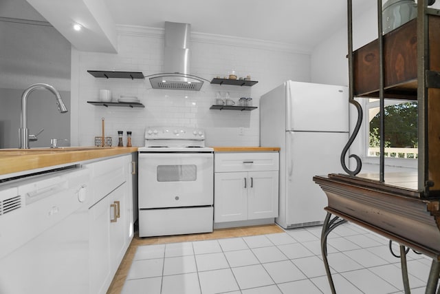 kitchen with white appliances, wall chimney exhaust hood, decorative backsplash, white cabinets, and sink