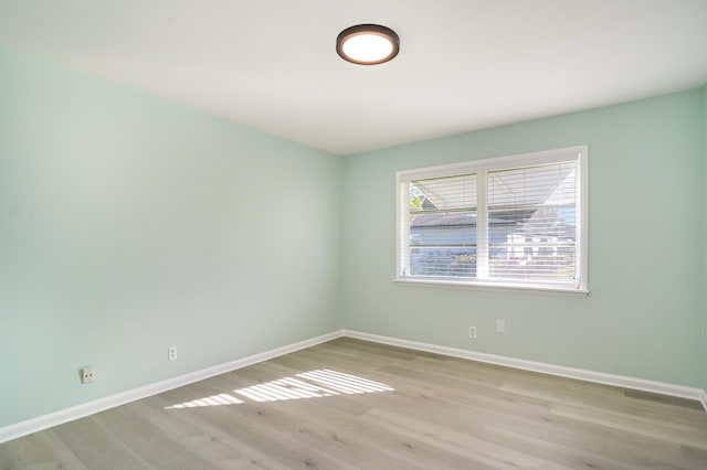 unfurnished room with light wood-type flooring