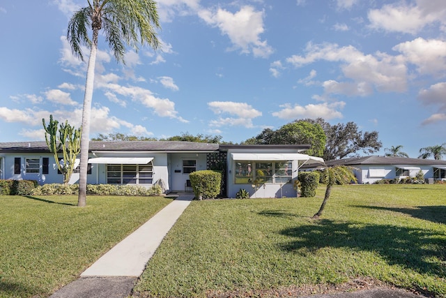 ranch-style house with a front lawn