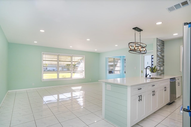 kitchen featuring sink, light tile patterned floors, a chandelier, pendant lighting, and white cabinets