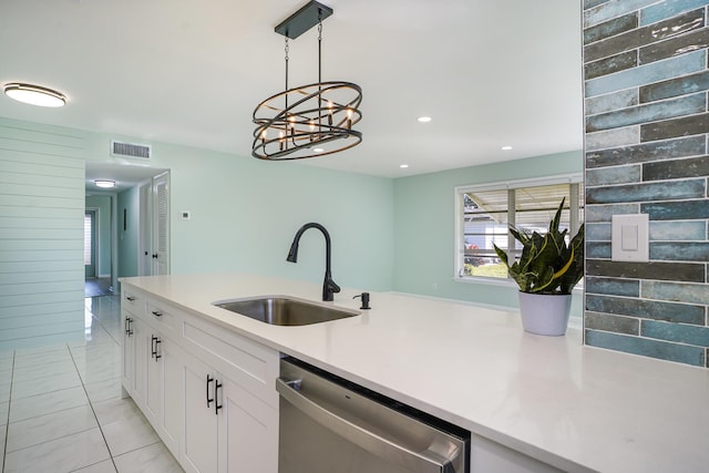 kitchen with sink, light tile patterned floors, decorative light fixtures, dishwasher, and white cabinetry