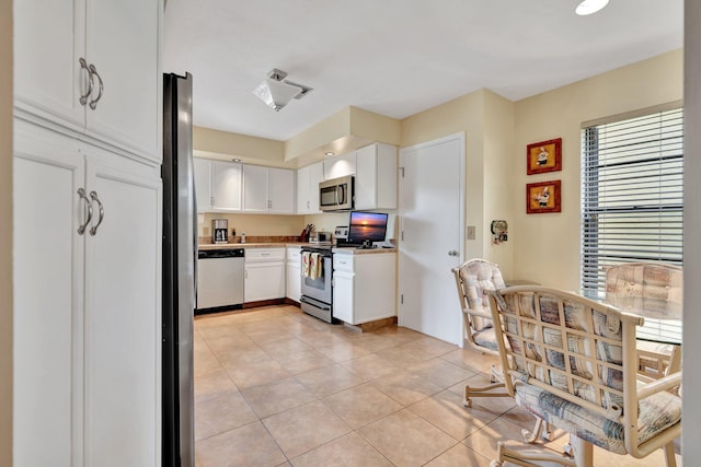 kitchen featuring white cabinets, light tile patterned floors, and appliances with stainless steel finishes