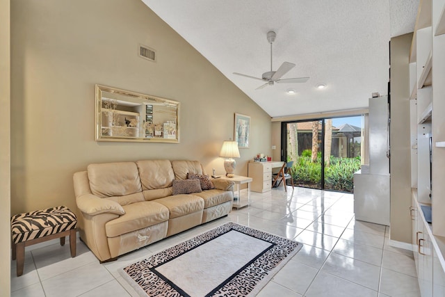 tiled living room with a textured ceiling, high vaulted ceiling, and ceiling fan