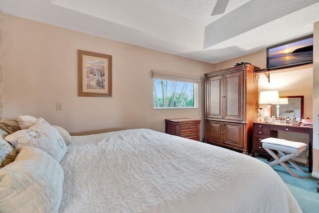 carpeted bedroom with a textured ceiling and ceiling fan