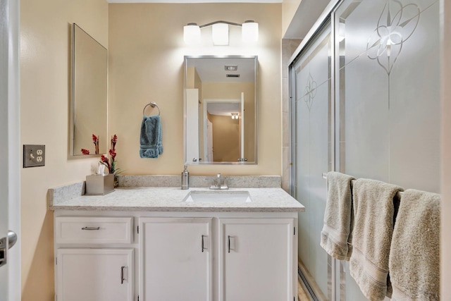 bathroom featuring vanity and an enclosed shower