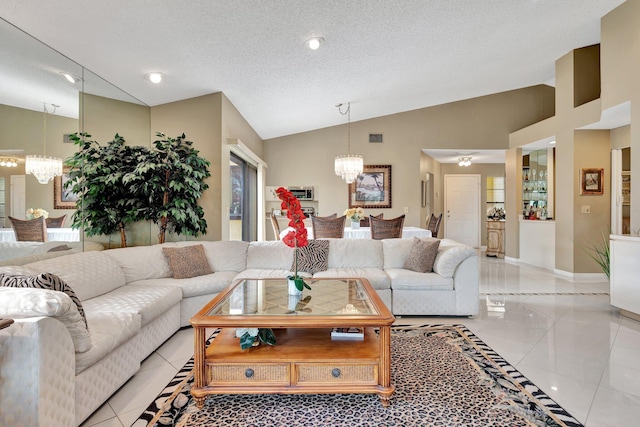 living room featuring a chandelier, light tile patterned floors, a textured ceiling, and lofted ceiling