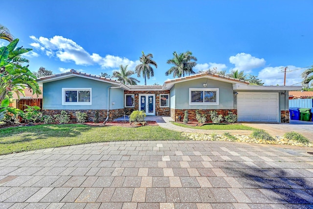 ranch-style house with a front yard and a garage