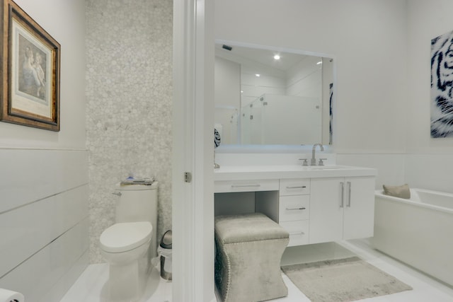 bathroom featuring tile patterned flooring, vanity, tile walls, and toilet