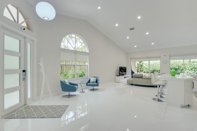 living room featuring crown molding, lofted ceiling, and light tile patterned flooring