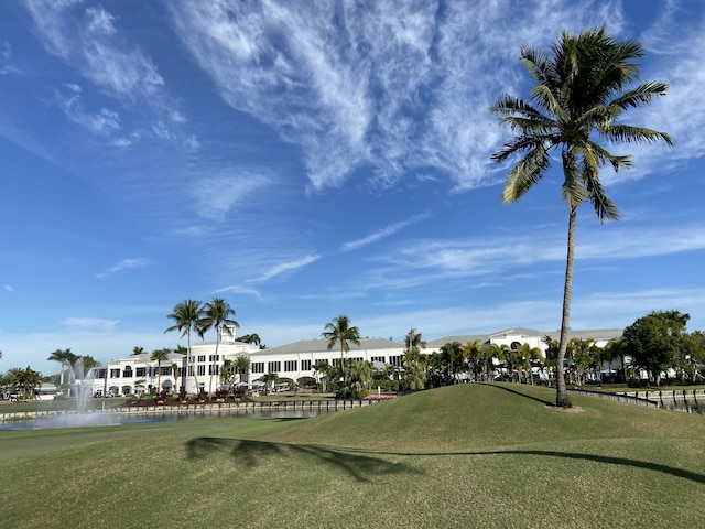 view of home's community with a yard and a water view