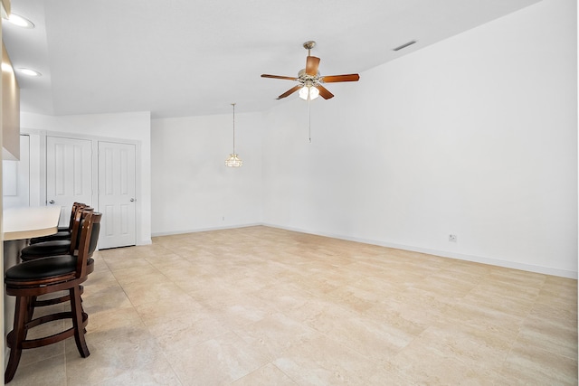 interior space featuring ceiling fan and lofted ceiling