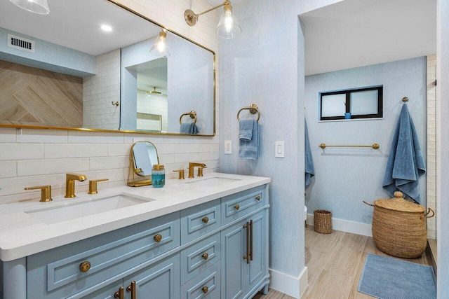 bathroom featuring backsplash, vanity, and hardwood / wood-style floors