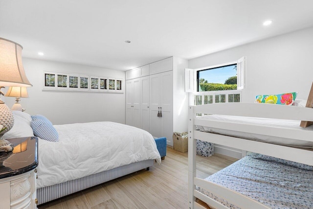 bedroom featuring light wood-type flooring and a closet