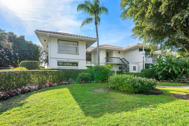 mediterranean / spanish house with a front yard