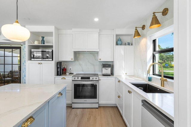 kitchen with white cabinets, appliances with stainless steel finishes, and sink