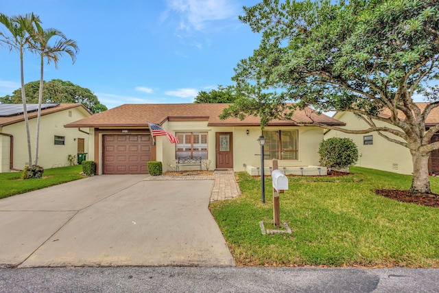 single story home featuring a garage and a front lawn