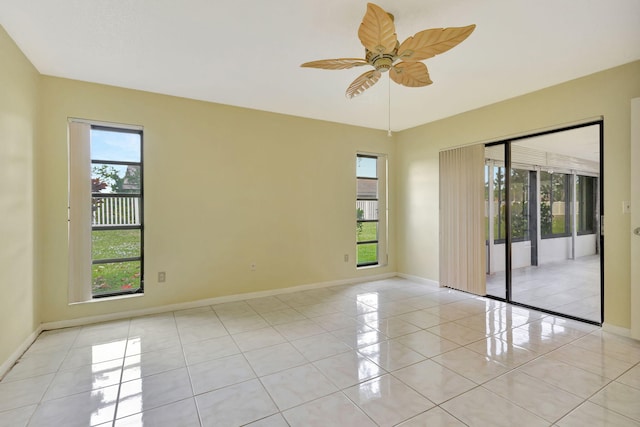 spare room with plenty of natural light, ceiling fan, and light tile patterned floors