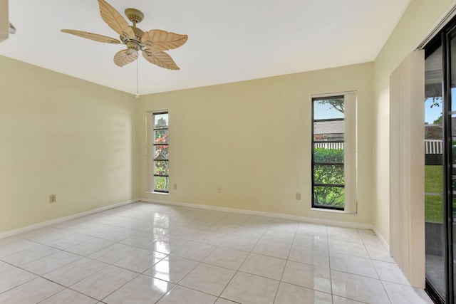 tiled spare room with ceiling fan