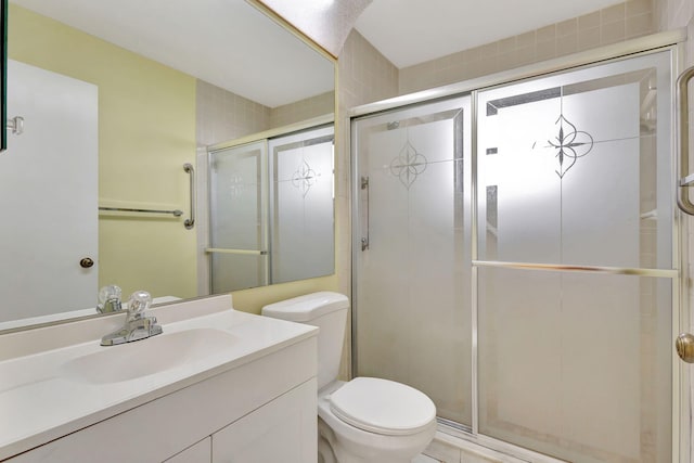 bathroom with vanity, an enclosed shower, and toilet