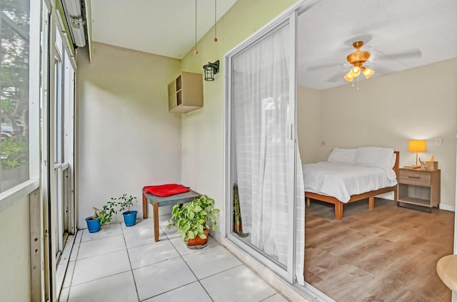 bedroom with ceiling fan and light tile patterned floors