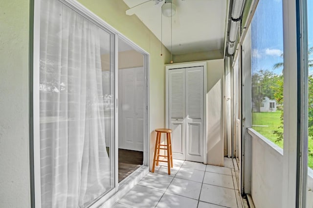 unfurnished sunroom with ceiling fan