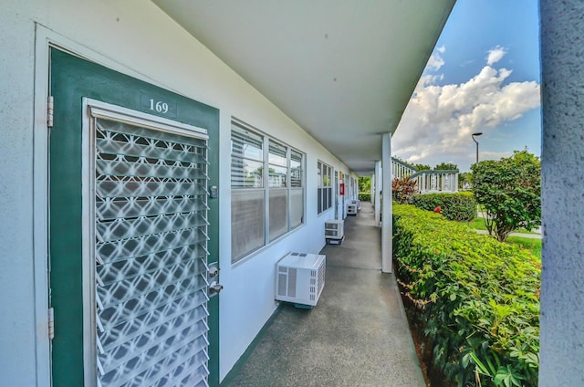 exterior space with a wall mounted air conditioner