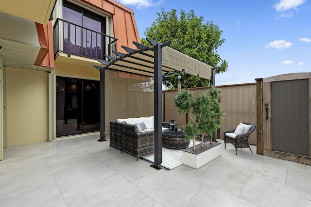 view of patio with outdoor lounge area, fence, a balcony, and a pergola