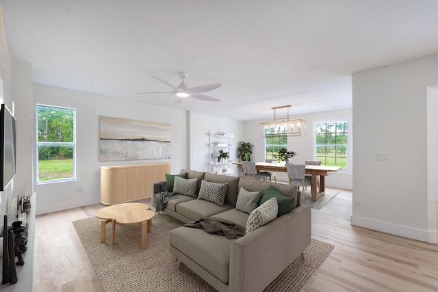 living room with ceiling fan and light hardwood / wood-style floors