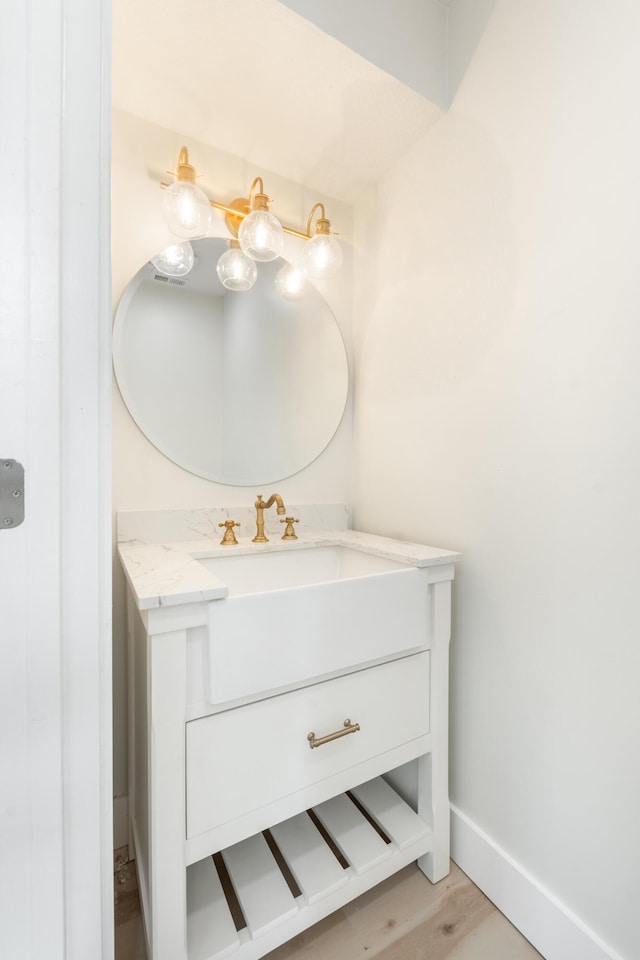 bathroom with hardwood / wood-style floors and vanity