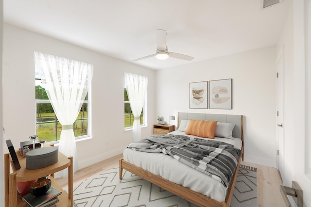 bedroom with ceiling fan and light hardwood / wood-style flooring