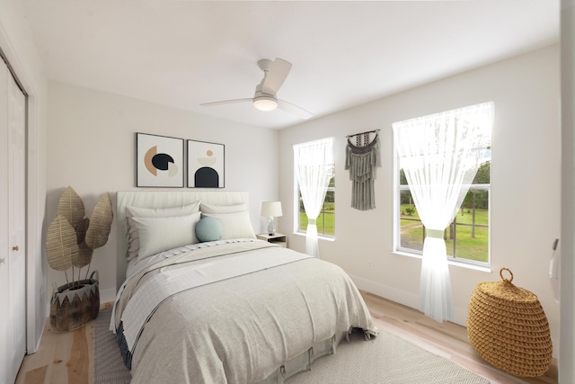 bedroom with light hardwood / wood-style flooring, a closet, and ceiling fan