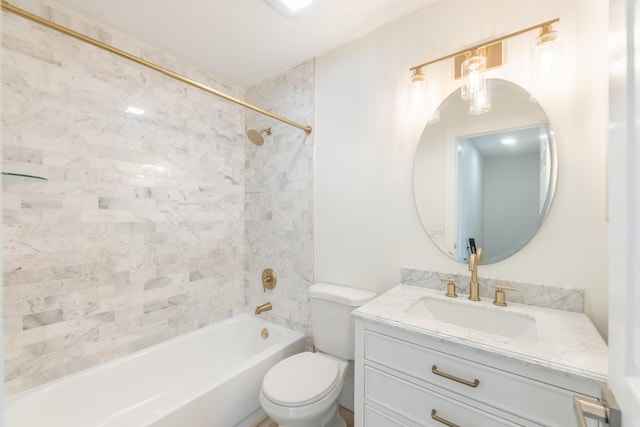 full bathroom featuring vanity, tiled shower / bath, and toilet