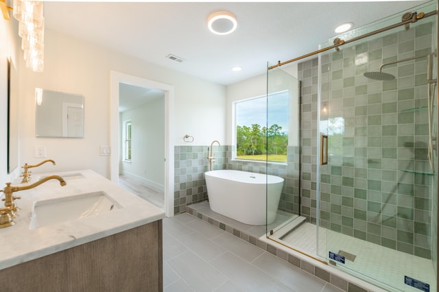 bathroom with tile patterned flooring, vanity, separate shower and tub, and tile walls