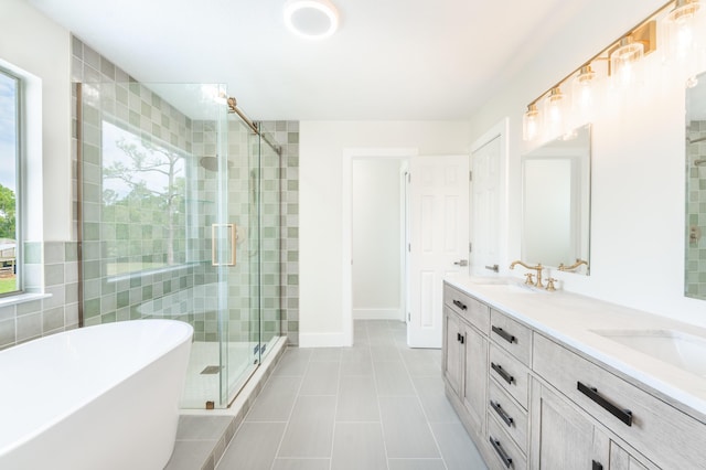 bathroom with tile patterned floors, a wealth of natural light, vanity, and shower with separate bathtub