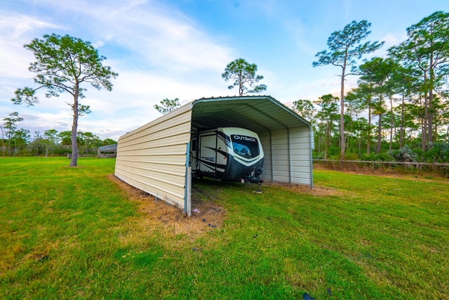 view of outdoor structure with a lawn and a carport