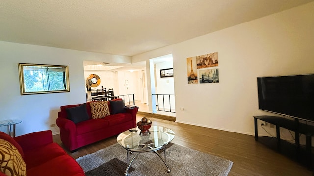 living room with dark hardwood / wood-style flooring and a textured ceiling