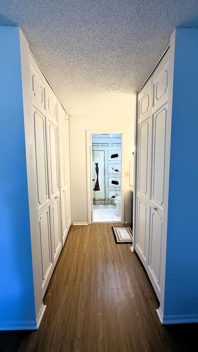 3650 Inverrary Dr Unit 3C, Lauderhill, FL 33319 - hall with dark wood-style flooring, a textured ceiling, and baseboards
