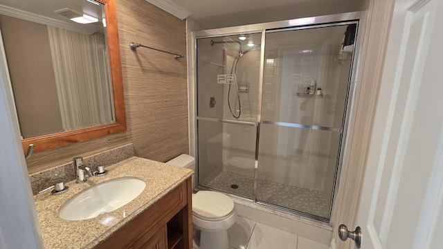 bathroom with vanity, toilet, and a shower with door