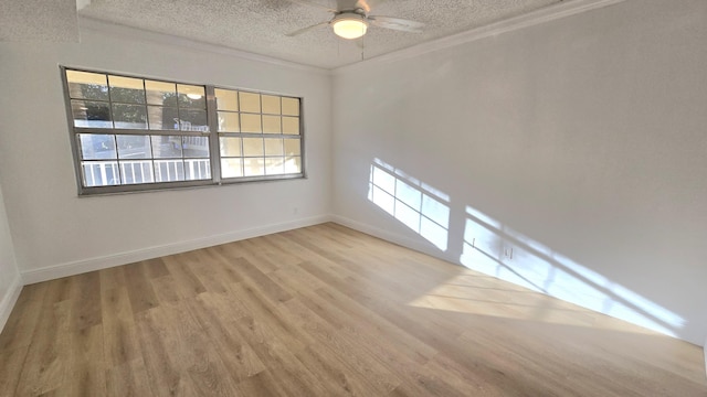 empty room with a textured ceiling, light hardwood / wood-style floors, ceiling fan, and crown molding