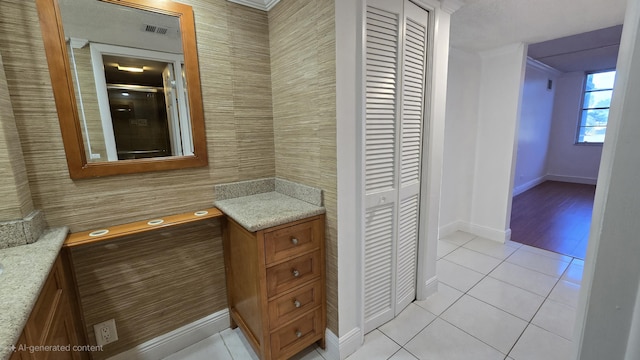 bathroom featuring tile patterned flooring and an enclosed shower